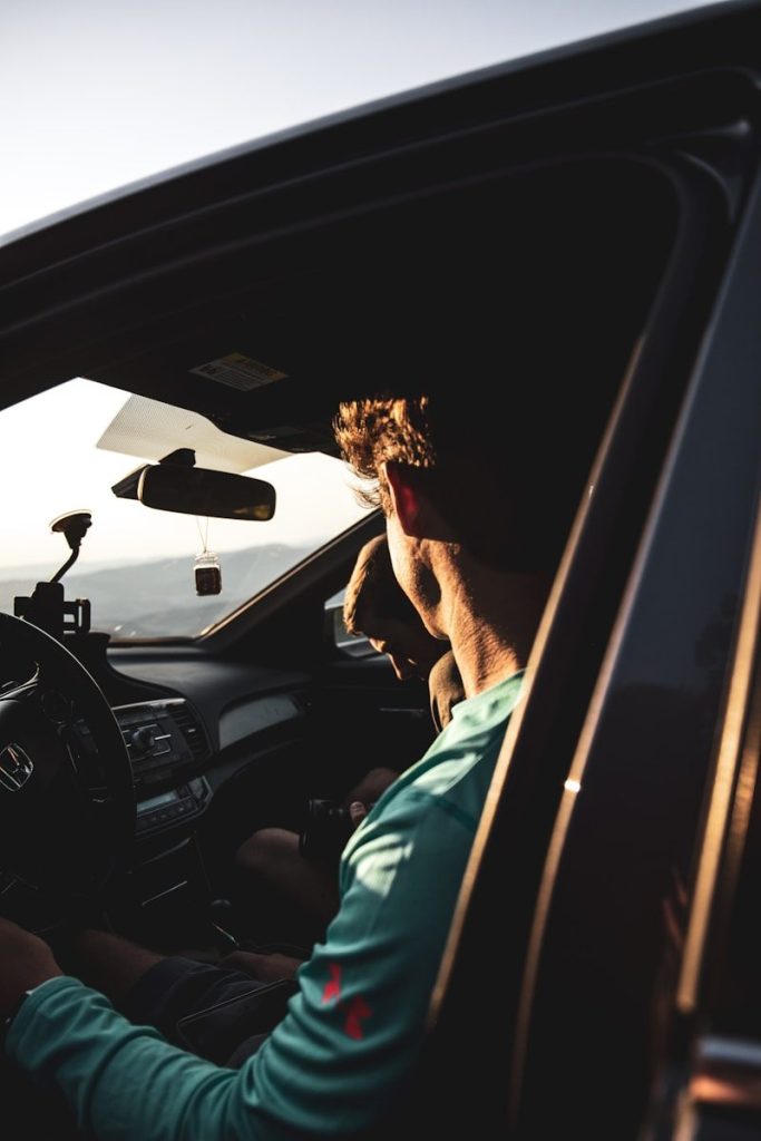 woman in green shirt driving car