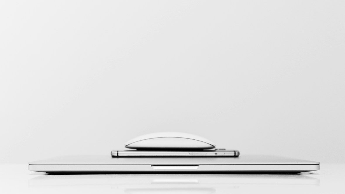 a laptop computer sitting on top of a white desk