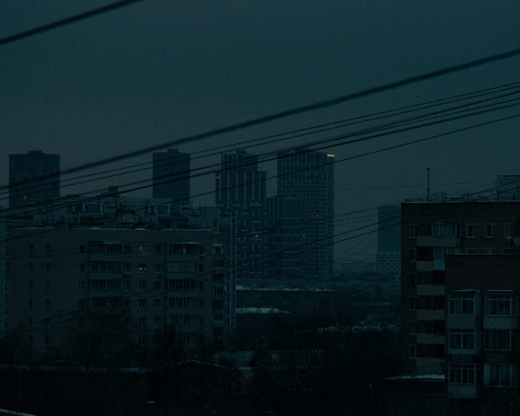a view of a city at night with a full moon