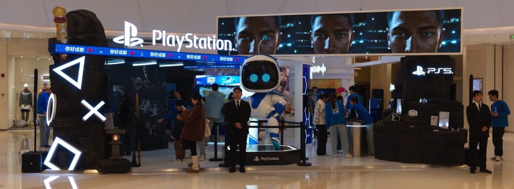 Playstation booth with astro bot mascot and game displays
