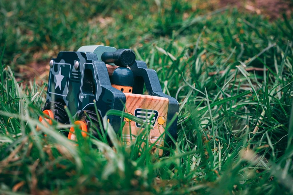 black and brown toy gun on green grass