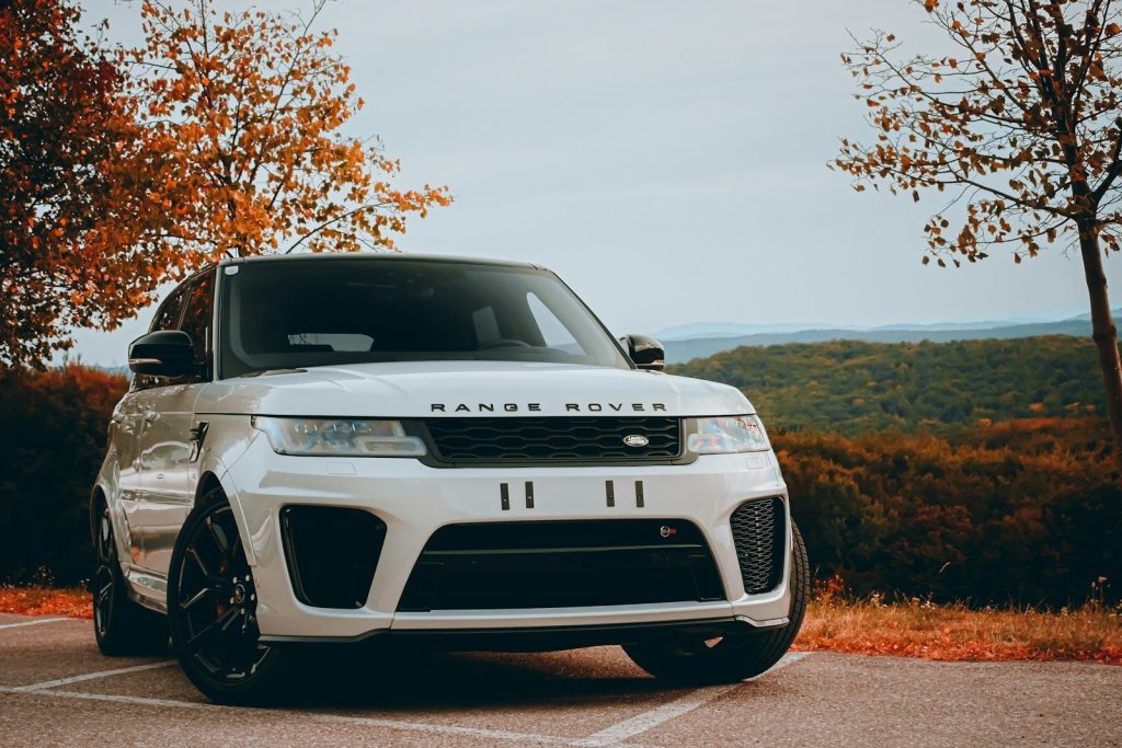 A white range rover parked in a parking lot