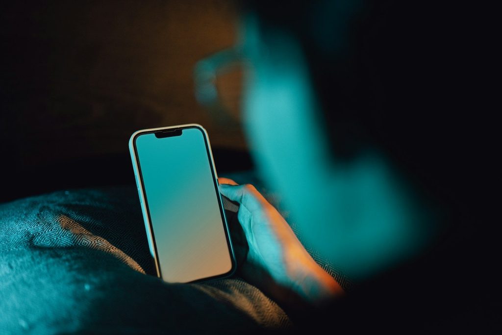 A person holding a cell phone in their hand