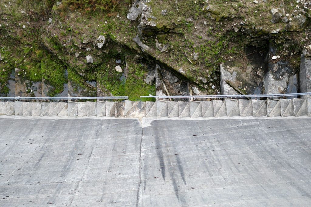 Dam wall and mountain side.