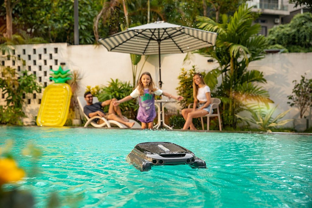 A group of people sitting around a pool
