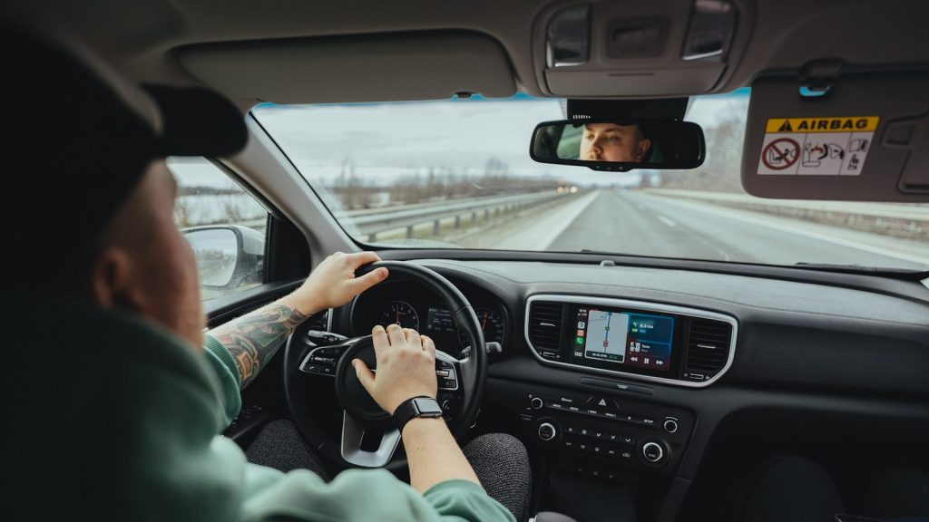 person driving car during daytime