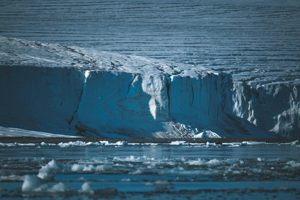 A large iceberg floating in the middle of the ocean