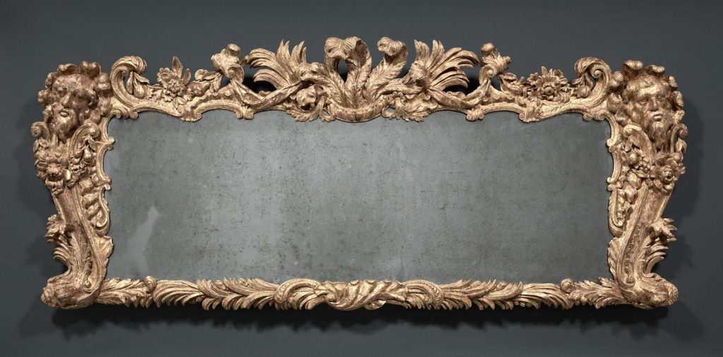 Ornate gilded mirror with carved floral details