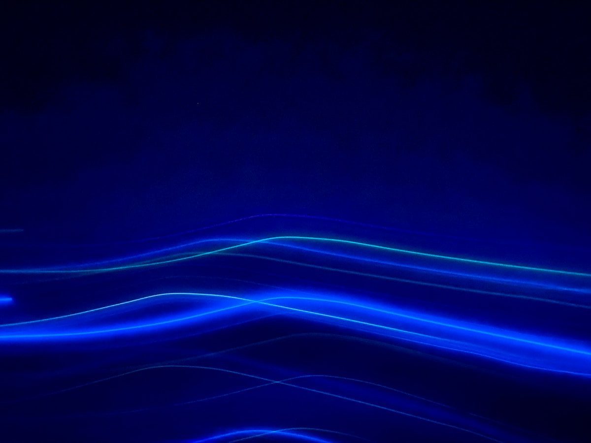 a dark blue background with lines of light