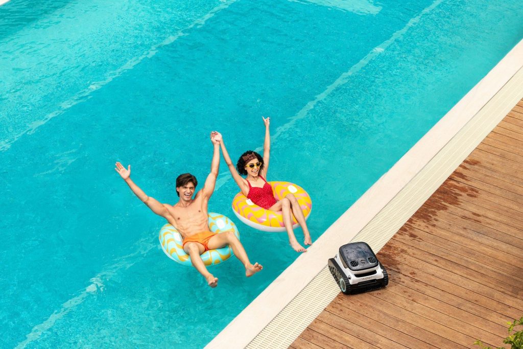 A couple of people that are in a pool