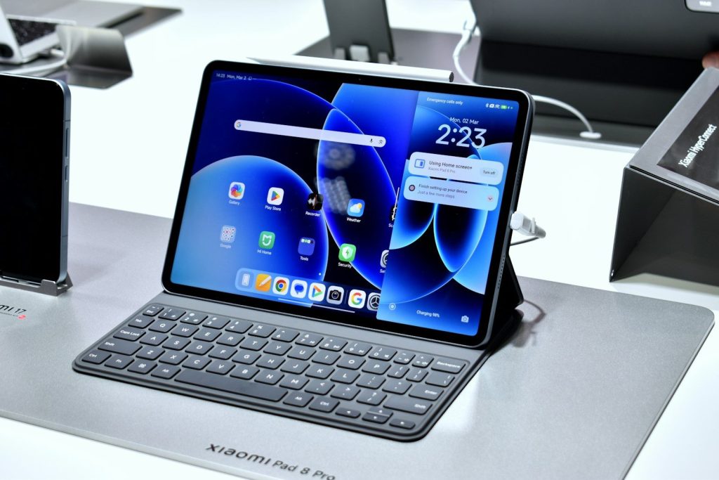 A tablet with a keyboard and stylus displayed.