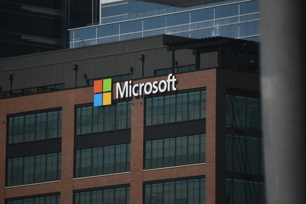 A tall building with a microsoft logo on top of it