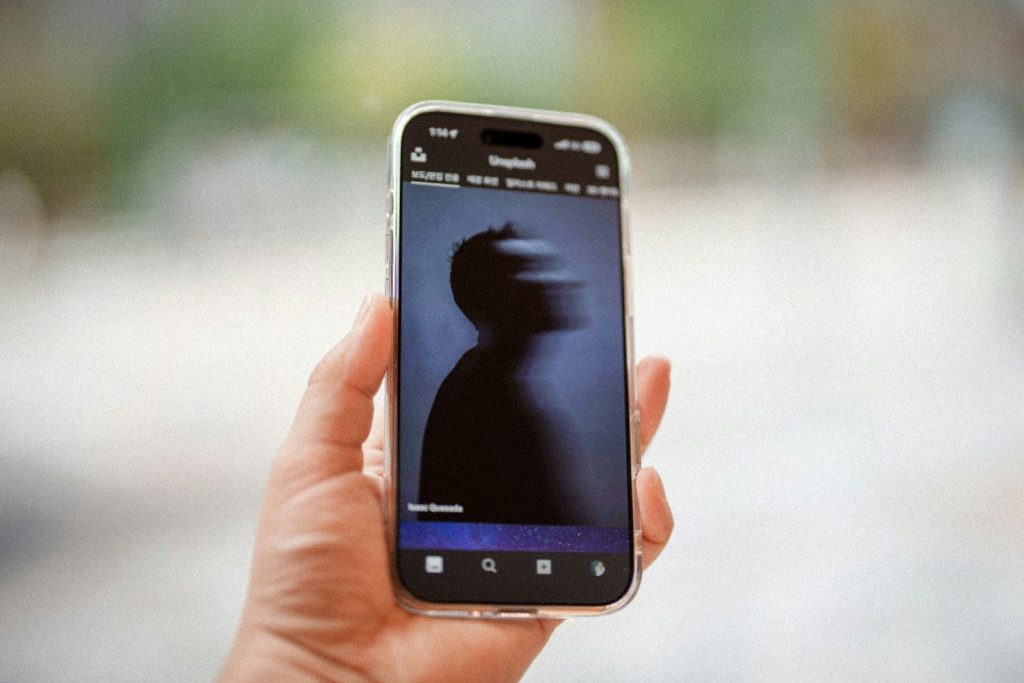 Phone displaying silhouette of a person's head