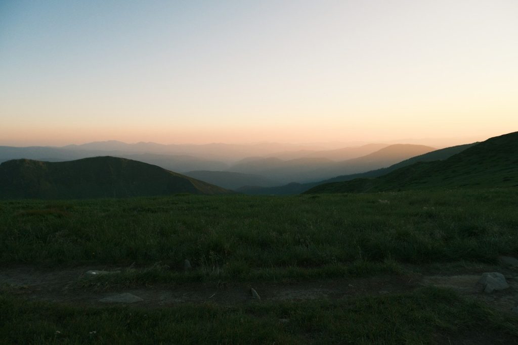Rolling hills at dusk with a soft pastel sky