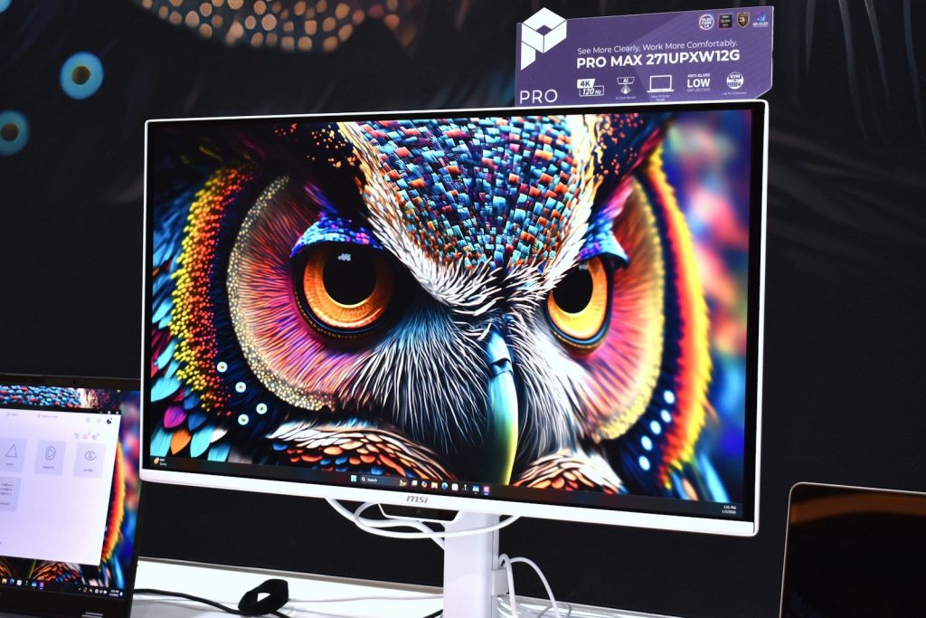 A vibrant, colorful owl artwork displayed on a modern monitor.