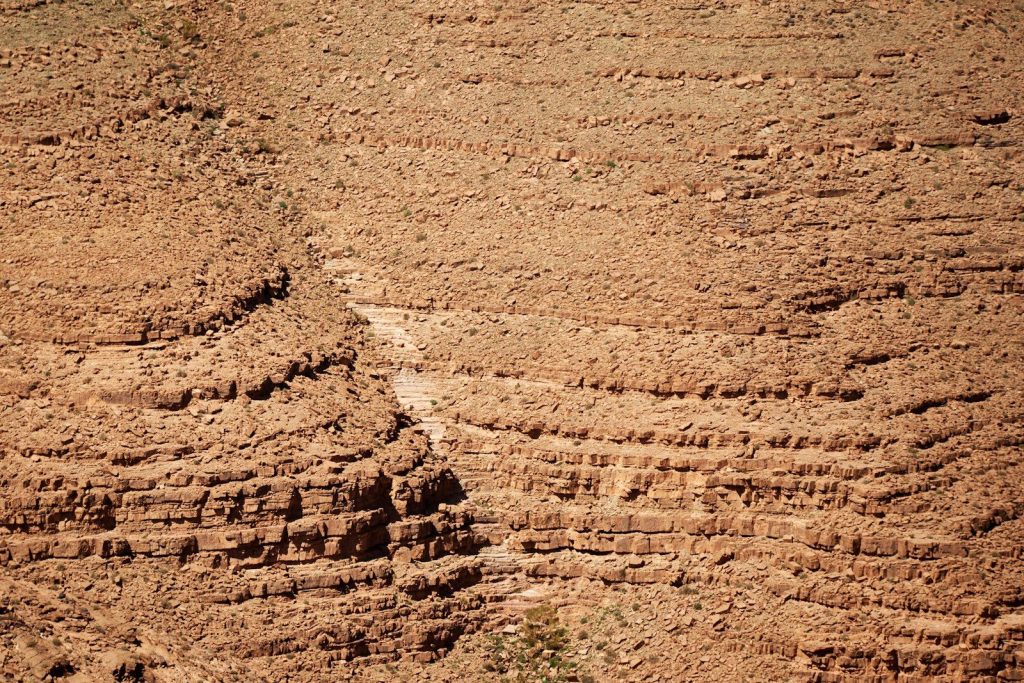 a dirt field with a white line in the middle of it