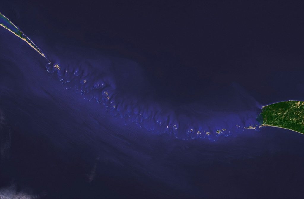 Aerial view of a chain of islands in the ocean.
