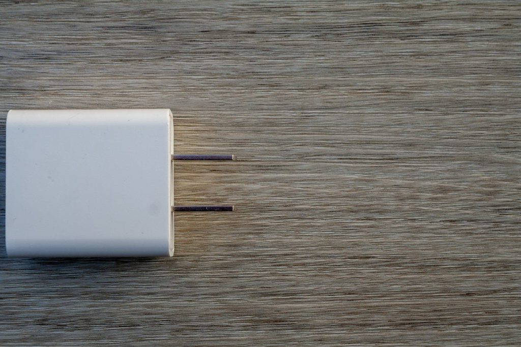 White electrical adapter on a wooden surface