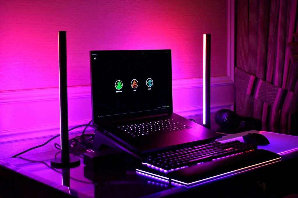 Gaming setup with laptop, keyboard, and rgb lighting.