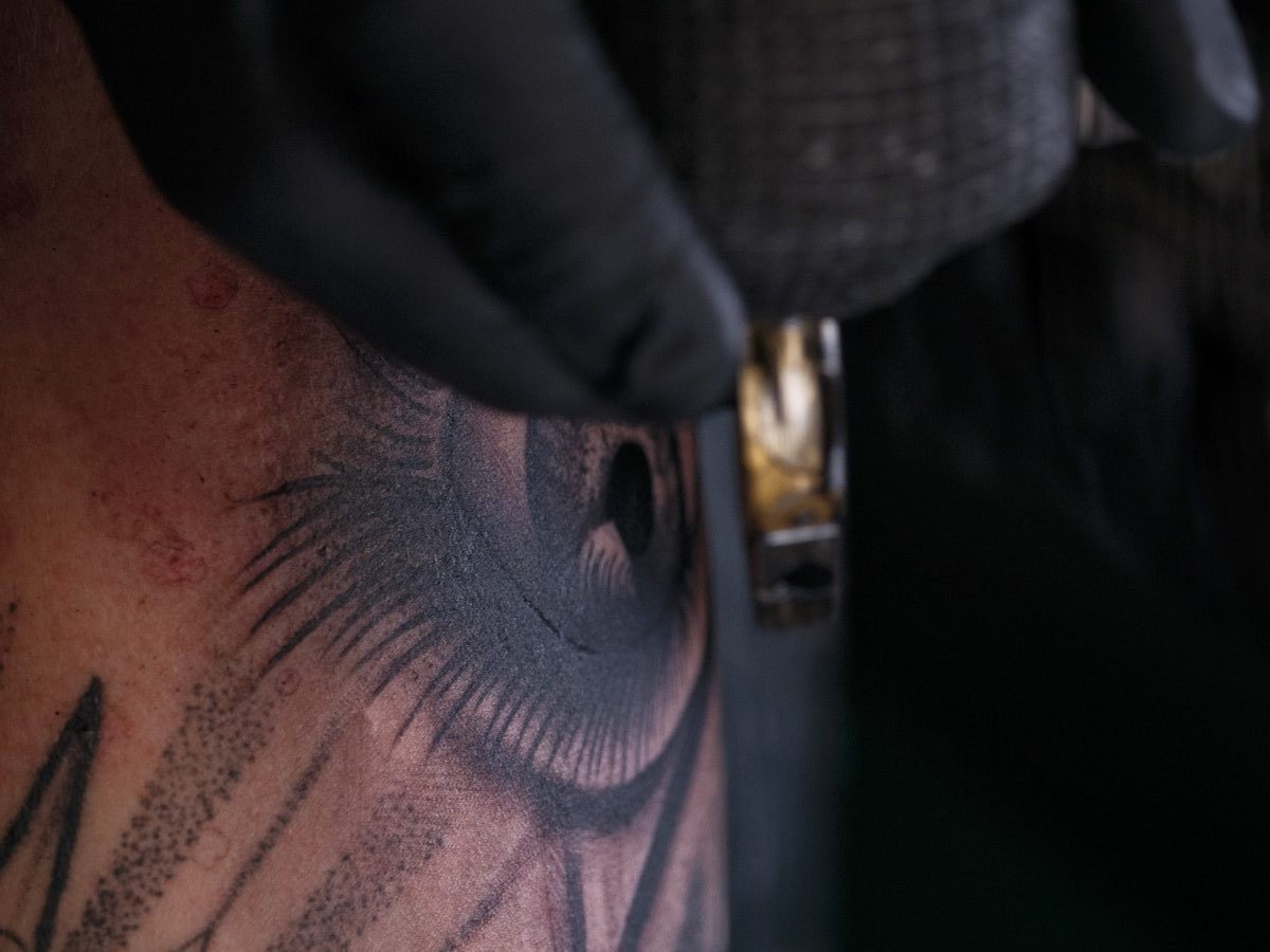 Tattoo artist working on eye design