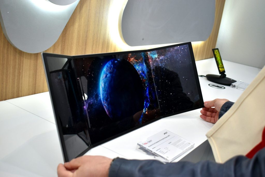 Curved screen displaying a blue planet in space.