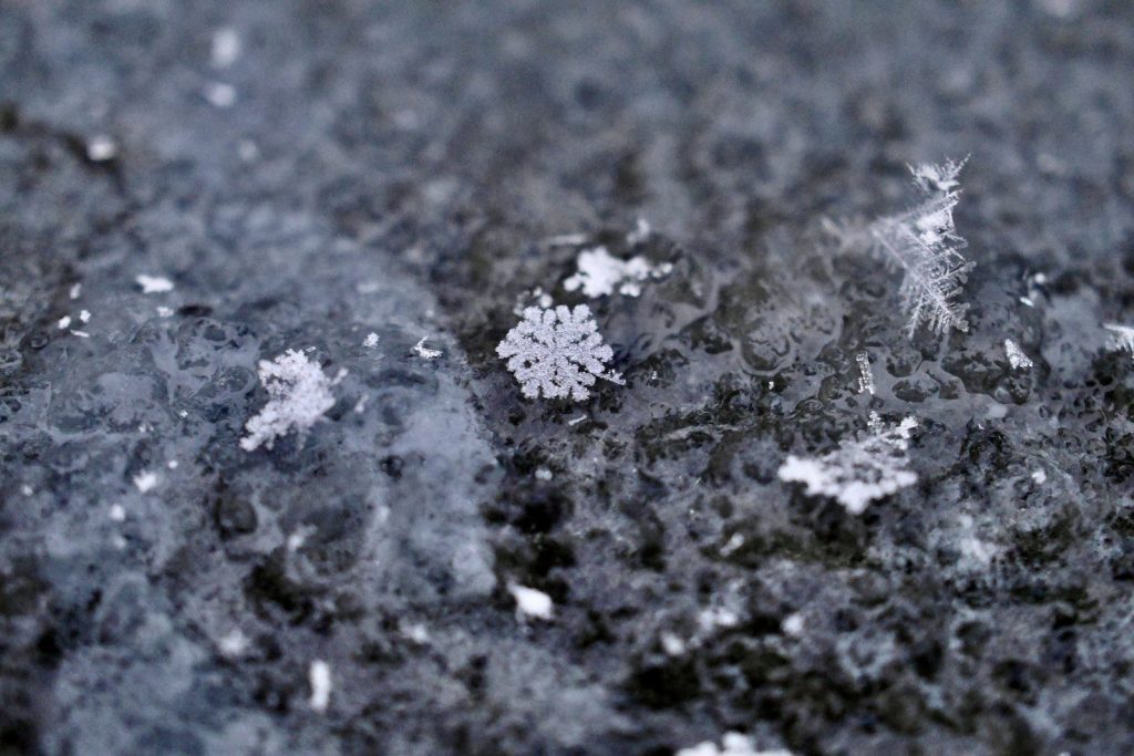 white snow on black sand