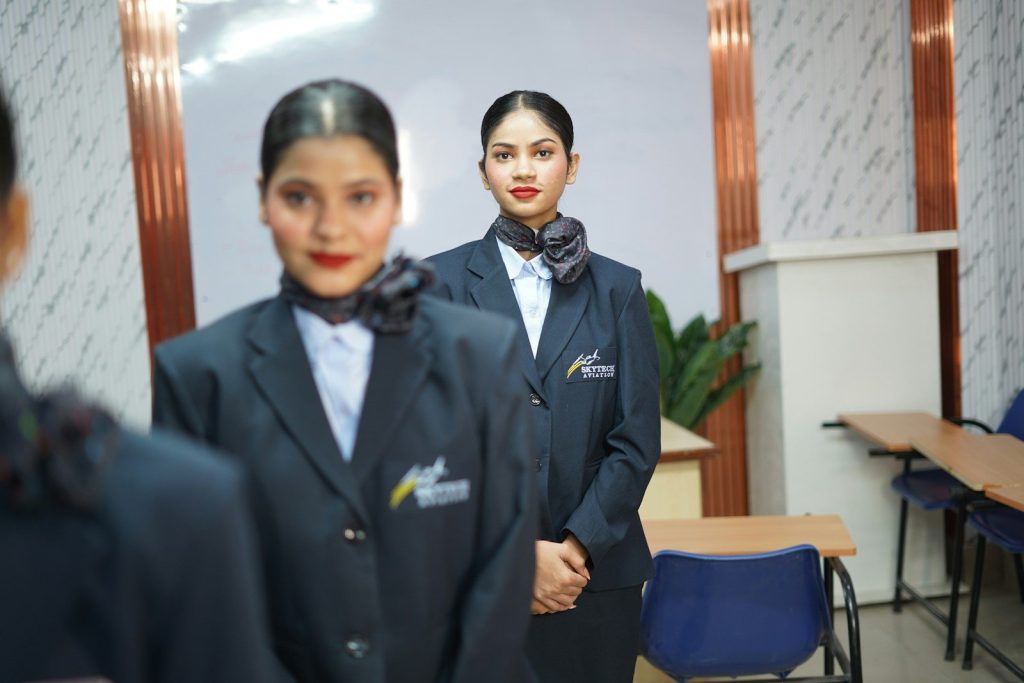 Two women in uniform standing in a classroom.