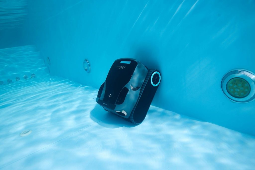 A robotic pool cleaner is underwater.