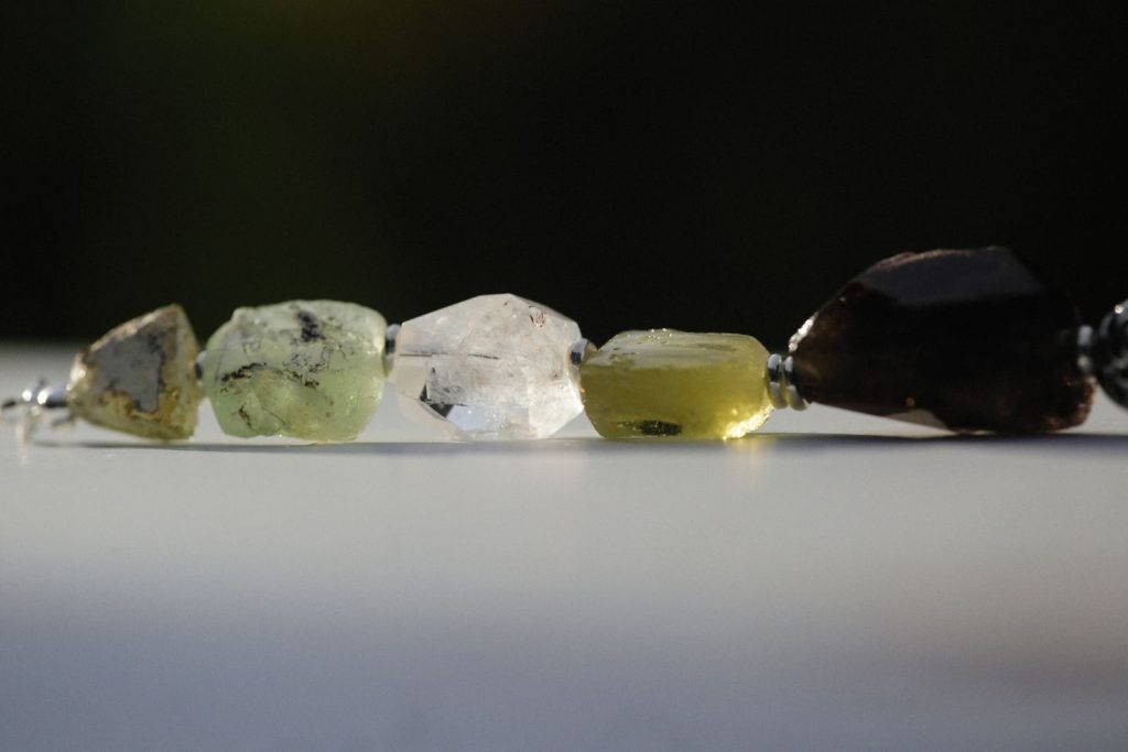 Detailed view of a necklace featuring raw gemstone beads with a natural aesthetic.