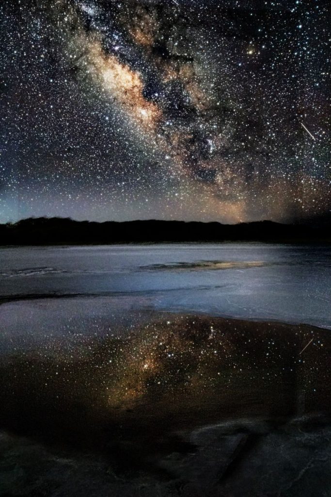 Stunning Milky Way reflection on Golfo de Santa Clara beach at night.
