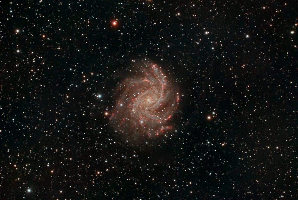 Capture of a spiral galaxy surrounded by stars, showcasing the vastness of space.