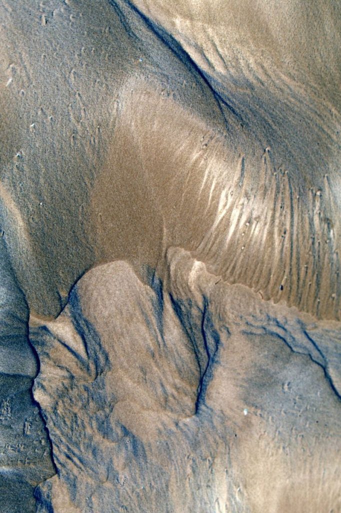 Artistic aerial shot capturing abstract sand and water patterns on Guaratuba Beach, Brazil.