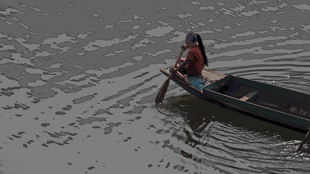 Person rowing a small boat on rippling water