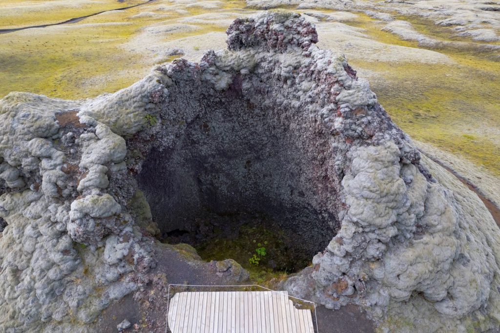A moss-covered spatter cone in Skaftárhreppur, Iceland's volcanic landscape.