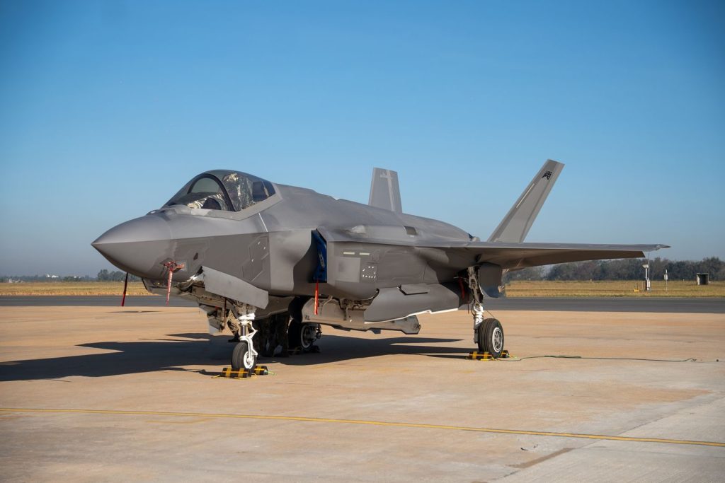 A state-of-the-art military jet on a sunny runway at an airshow in Bengaluru, India, showcasing modern aviation technology.