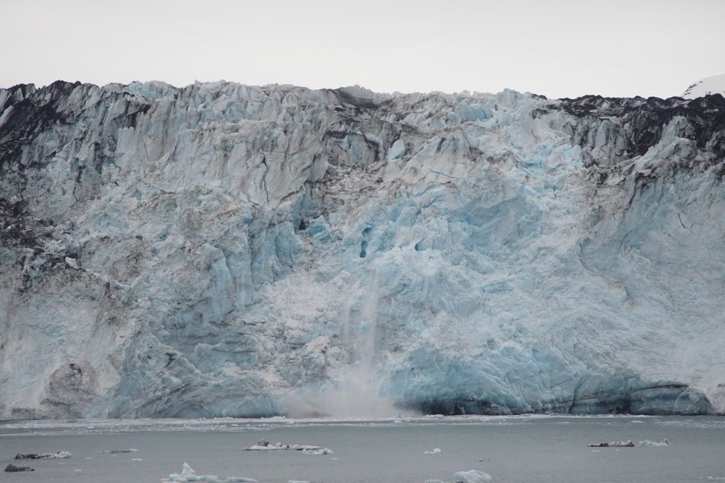 Stunning view of a glacier calving into the ocean, showcasing nature's raw power and beauty.