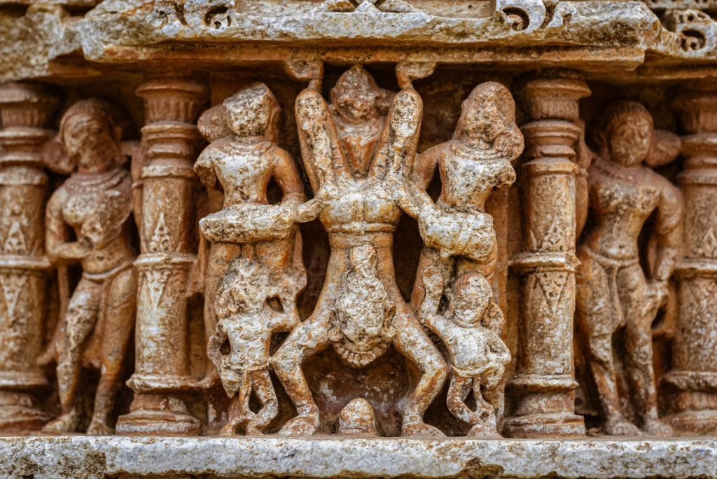 Close-up of intricate stone carvings depicting Hindu mythology at Eklingji Temple, Rajasthan.