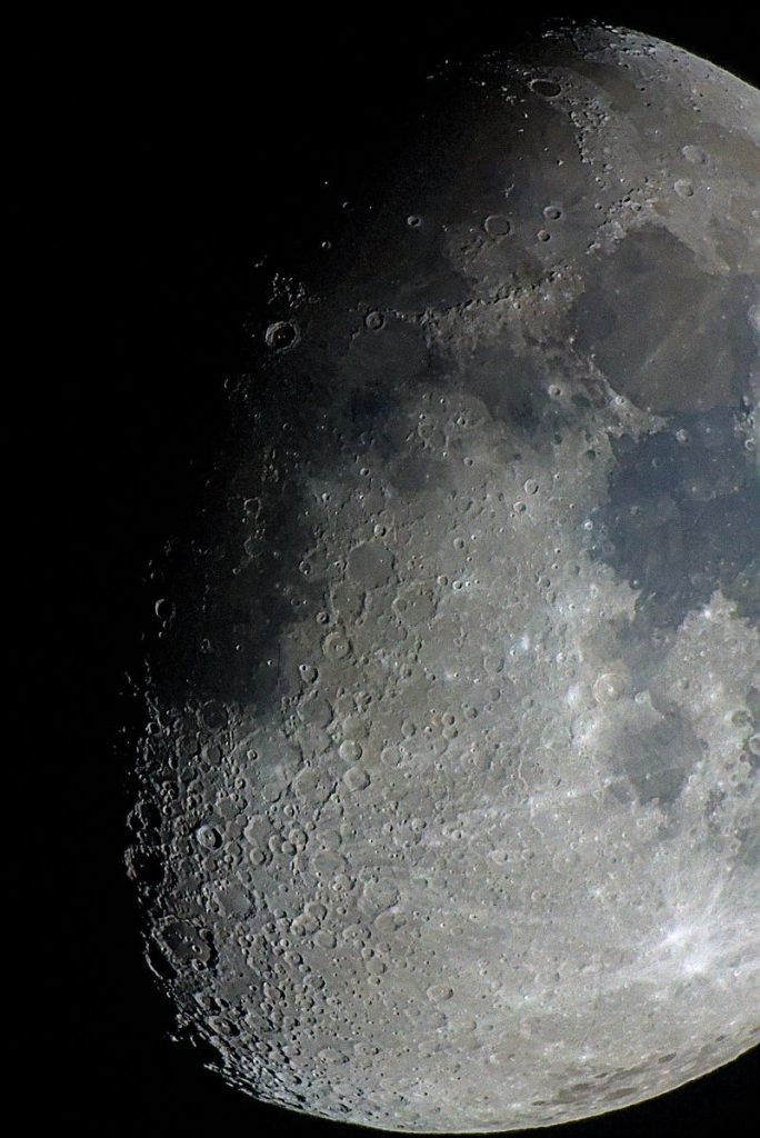 Close-up of moon's surface showcasing craters and textures.
