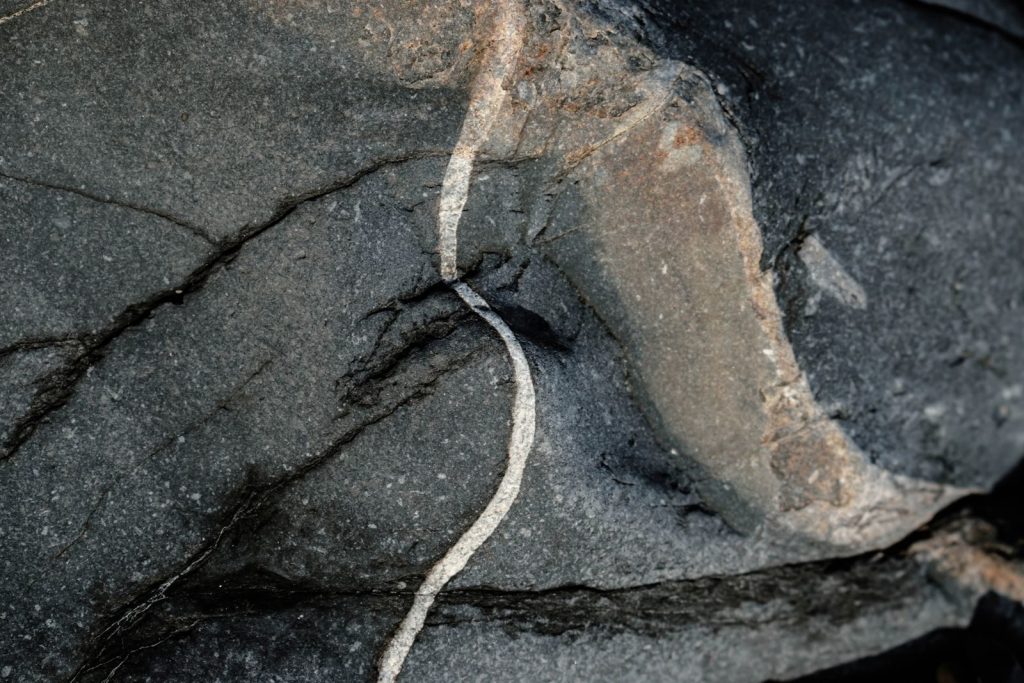 Detailed close-up of a natural rock formation with striking patterns and textures.