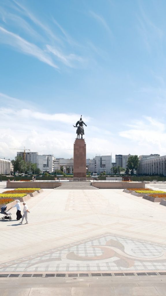 Equestrian statue on a pedestal in a city square.