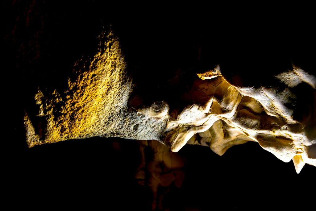 Cave formations illuminated by dramatic lighting