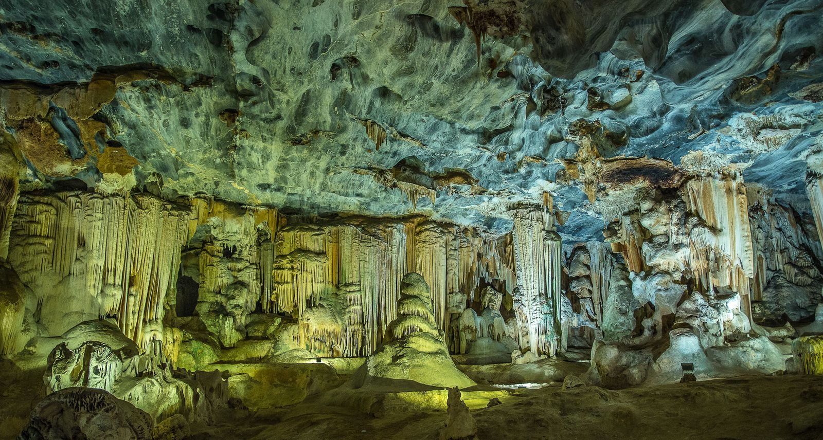 Explore the intricate limestone formations and stalactites in a stunning underground cave.