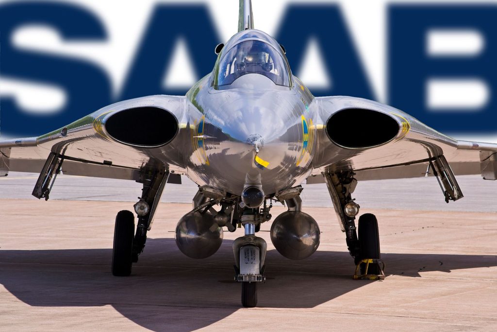 Close-up of a J 35 Draken fighter jet, showcasing its sleek design and parked under a SAAB logo.