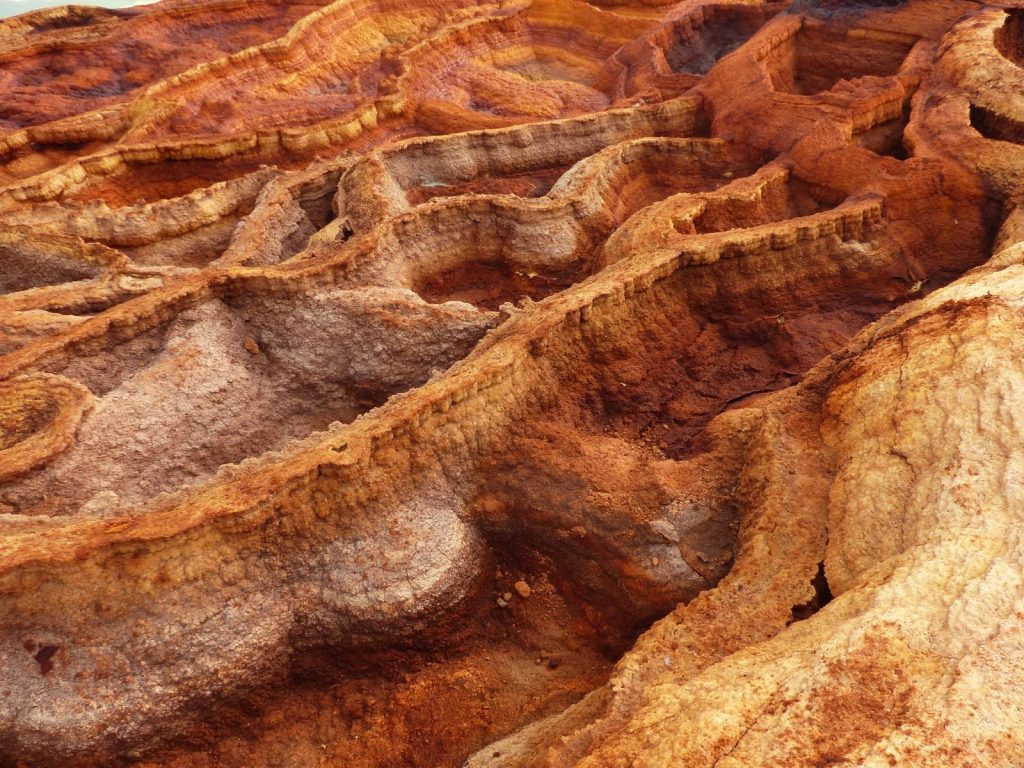 From above of rough massive rocky formation with uneven surface as abstract background