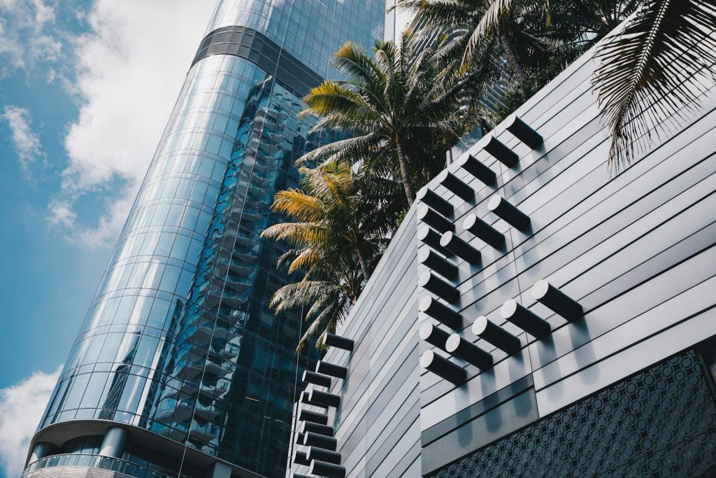 Modern architecture blends with palm trees.
