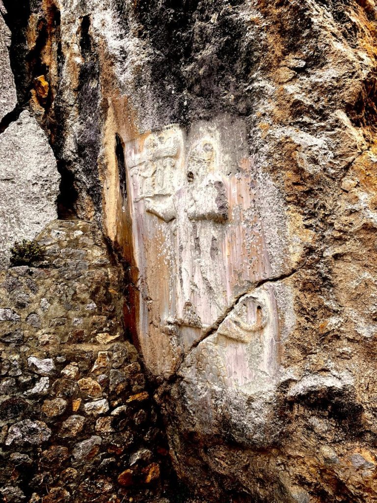 carvings carved into the side of a large rock
