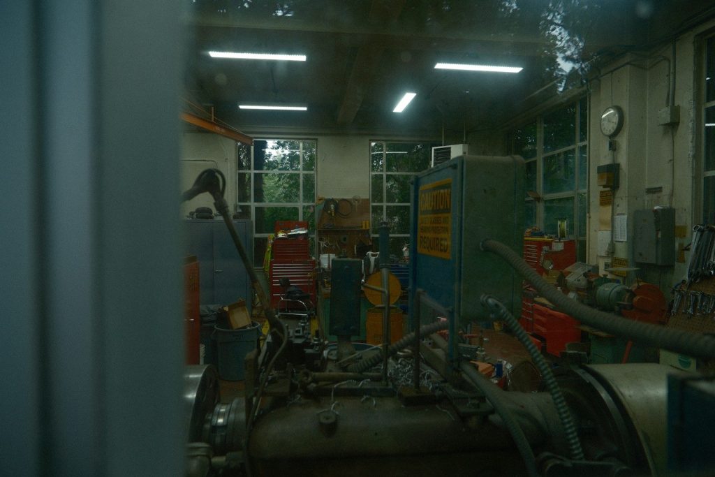 Workshop with machinery and tools visible through window