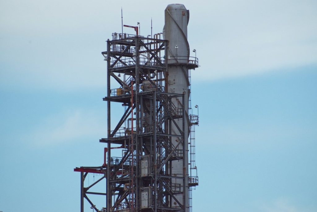 A large metal structure with a clock on top of it