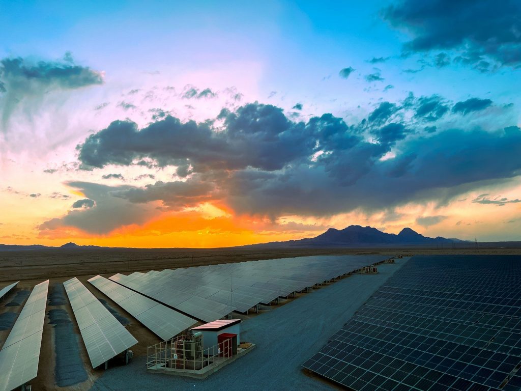 a large array of solar panels in a desert