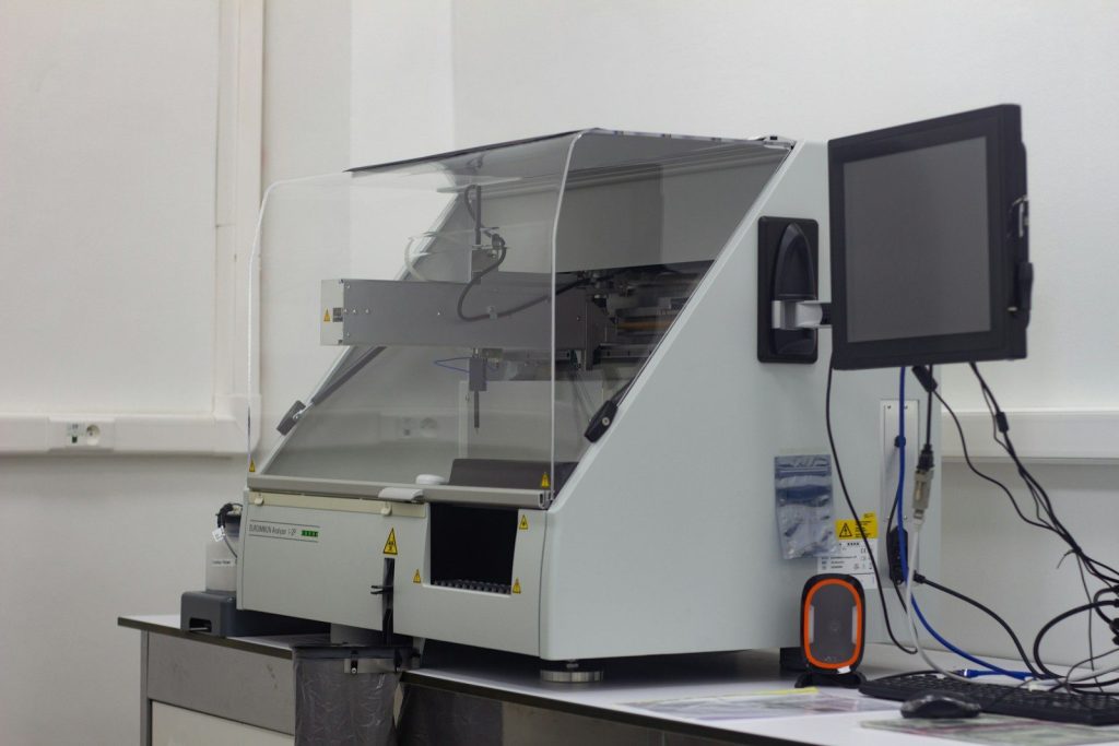 a large white machine with a monitor